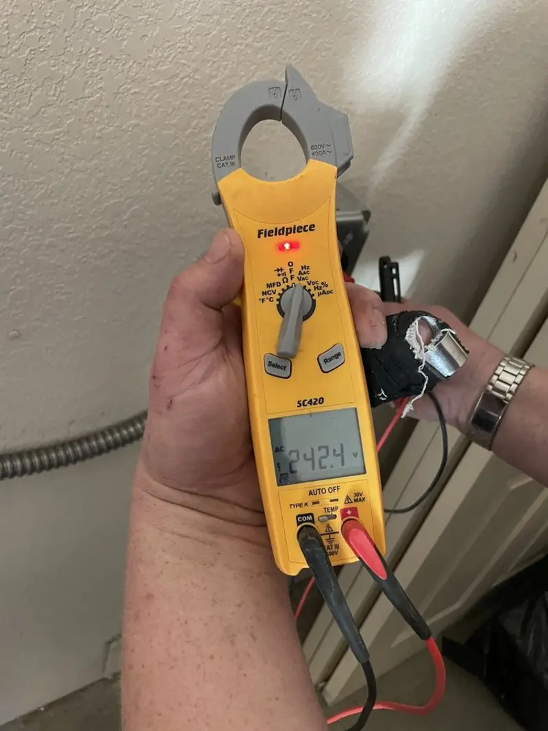 Voltage testing with clamp meter during Outlet Installation in Marshall
